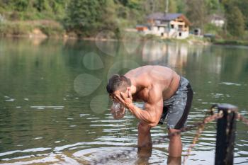 Attractive Man Standing In River And Enjoys The Nature