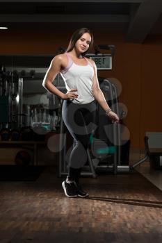 Portrait Of A Young Sporty Woman In The Gym With Exercise Equipment