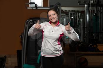 Portrait Of A Young Sporty Woman In The Gym With Exercise Equipment