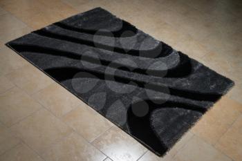 Black Carpet Lying On Floor