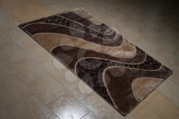 Brown Pattern Carpet Lying On Floor