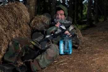 Paintball player resting on the ground