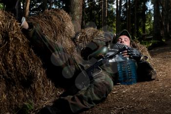 Paintball player resting on the ground