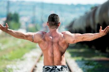 Man Showing His Back Double Biceps