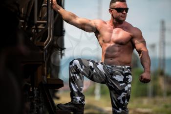 Male Bodybuilder Holding On To Train
