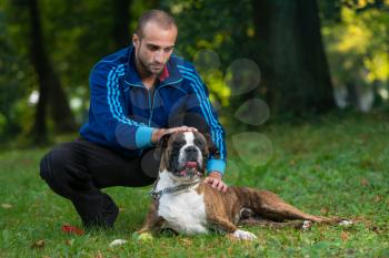 Man Playing With Dog In Park