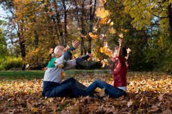 Couple Playing In The Leaves