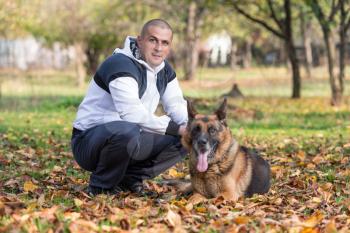 Man Holding Dog German Shepherd