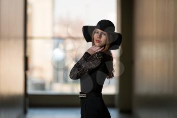 Elegant Lady With Stylish Hat And Leather Bag