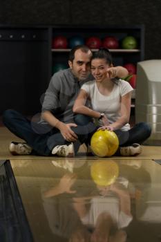 Man Teaching Woman Bowling