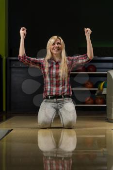 Ecstatic Bowling Women With Raised Hands