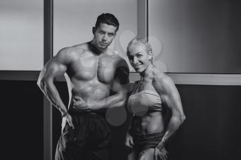 Strong Man And Woman Posing Bodybuilding
