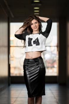 Fashion Model Wearing Leather Skirt And Long Sleeves