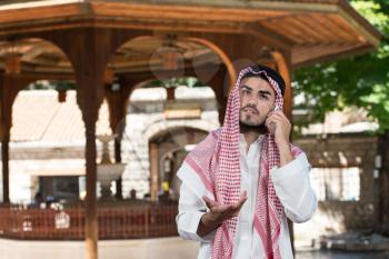 Young Businessman Wearing A Traditional Cap Dishdasha