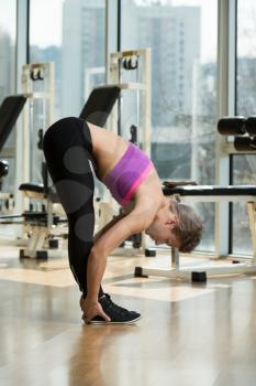 Fitness Woman Stretching  In A Healthy Club