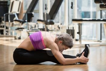 Fitness Woman Stretching On The Floor