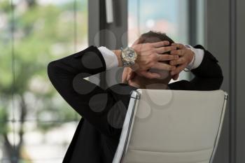 Man Relaxing With His Hands Behind His Head