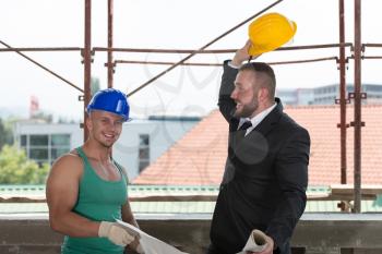 Group Of Male Architect And Construction Worker On Construction Site