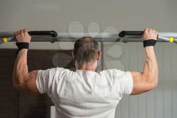 Male Athlete Doing Pull Ups - Chin-Ups In The Gym