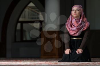 Young Muslim Woman Praying In Mosque