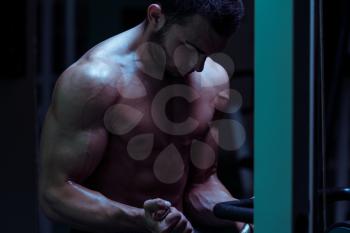 Young Bodybuilder Exercise In The Gym - He Is Performing Two Arm Biceps Push Up