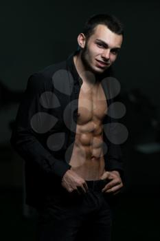 Young Attractive Male Model Standing In Unbuttoned Shirt
