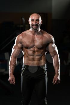 Portrait Of A Physically Fit Mature Man In A Healthy Club With Dramatic Lighting