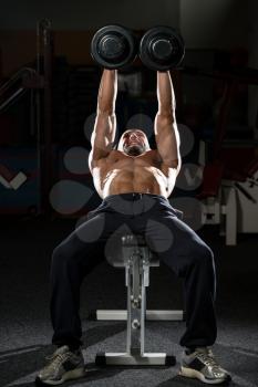 Mature Men Doing Dumbbell Incline Bench Press Workout In Gym