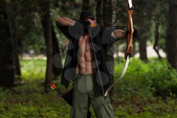 Beard Man With A Bow And Arrows In The Woods