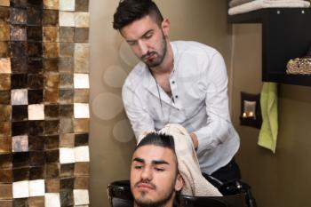 Hairstylist Hairdresser Washing Customer Hair - Young Man Relaxing In Hairdressing Beauty Salon