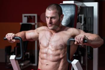 Male Bodybuilder Doing Heavy Weight Exercise For Chest