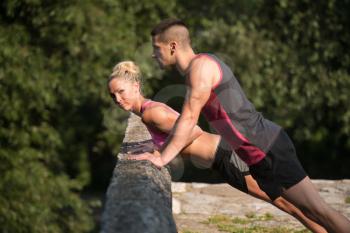 Young Couple Doing Pushups Before Running Outdoors - Fitness Healthy Lifestyle Concept