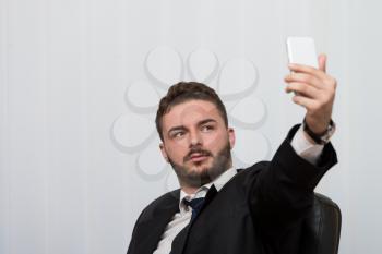 Young Businessman Working In His Office While Talking On The Phone