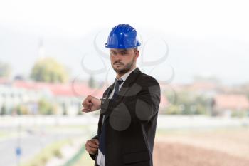 Businessman Looking At The Time On His Wrist Watch 