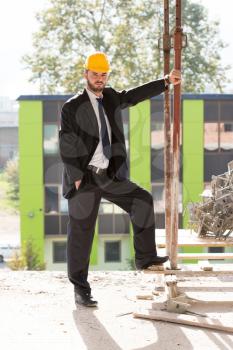 Portrait Of Business Man With Yellow Helmet On Construction