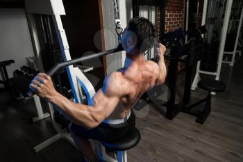 Bodybuilder Doing Heavy Weight Exercise For Back