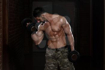 Healthy Man Working Out Biceps - Dumbbell Concentration Curls