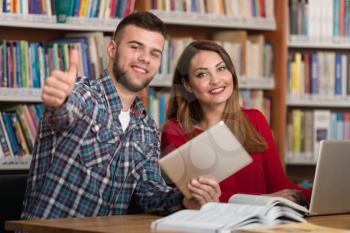 Portrait Of A Young Students Showing Thumbs Up In College Library - Shallow Depth Of Field