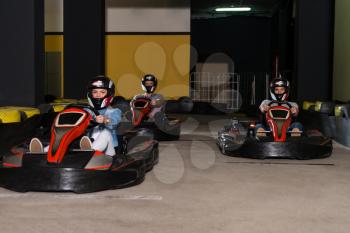 Group Of People Is Driving Go-Kart Car With Speed In A Playground Racing Track - Go Kart Is A Popular Leisure Motor Sports