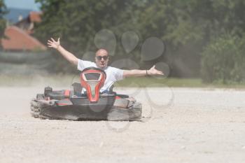 Young Man Is Driving Go-Kart Car With Speed In A Playground Racing Track - Go Kart Is A Popular Leisure Motor Sports