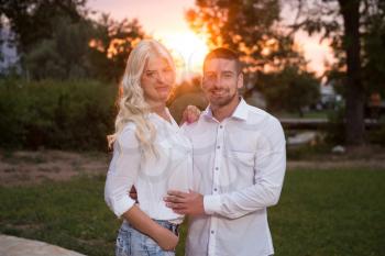 Young Couple In Love Outdoor - Stunning Sensual Outdoor Portrait Of Young Stylish Fashion Couple Posing In Summer In Field