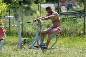 Handsome Muscular Young Man - Training On The Playground In Park