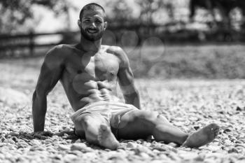 Smiling Handsome Guy Resting On Beach Outdoors