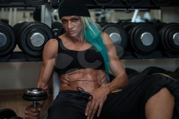 Good Looking And Attractive Middle Aged Woman With Muscular Body Relaxing In Gym