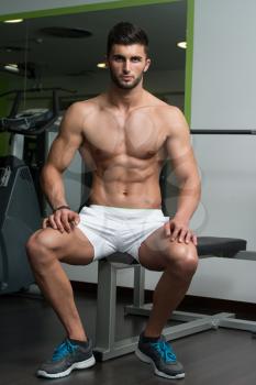 Portrait Of A Young Physically Fit Man Resting On Bench And Showing His Well Trained Body
