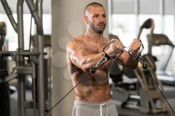 Bodybuilder Is Working On His Chest With Cable Crossover In Gym