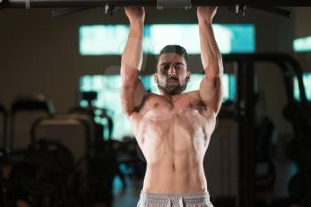 Young Muscular Fitness Bodybuilder Doing Heavy Weight Exercise For Back In The Gym