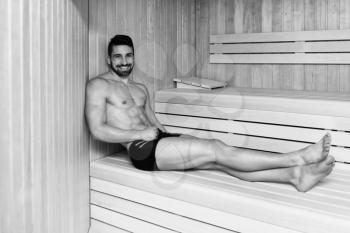 Happy Good Looking And Attractive Young Man With Muscular Body Relaxing In Hot Sauna