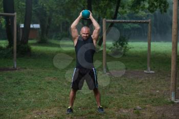 Young Fitness Male Exercise With Kettle Bell - Kettlebell Swing