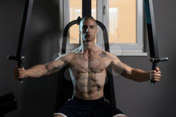 Butterfly Exercise Machine - Young Bodybuilder Doing Heavy Weight Exercise For Chest In The Gym